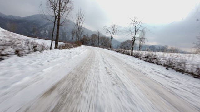 Winding snow-covered path in the winter landscape