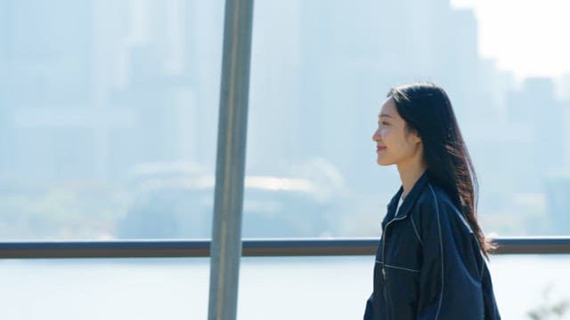 Woman jogging along a riverside path