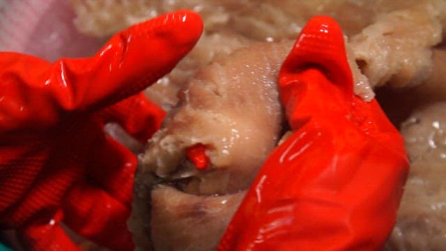 Boiled cow skin being cleaned in water