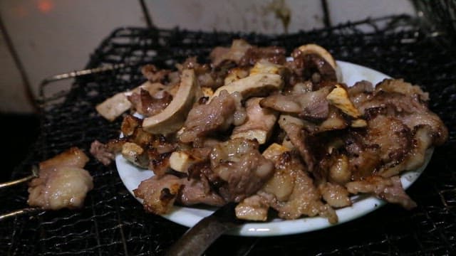 Beef tendon and mushrooms grilled over charcoal