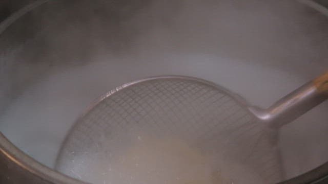 Noodles being cooked in boiling water