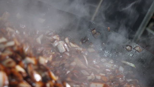 Cooking delicious black bean sauce in a large wok