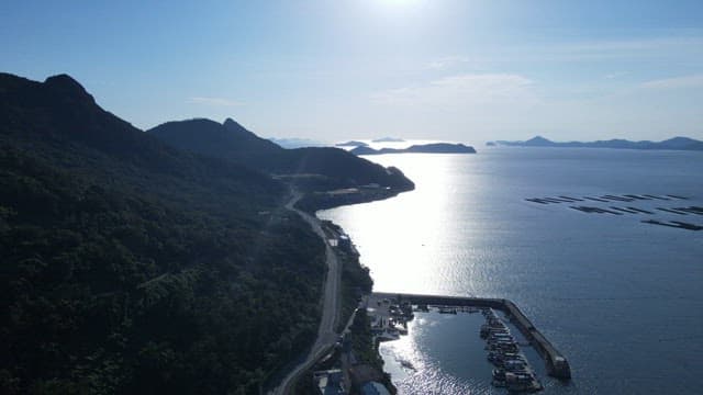 Aerial View of Coastal Road and Mountains