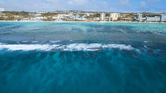 Sea Full of Coral Islands and Coastal Cityscape