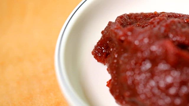 Red pepper paste in a white bowl