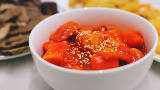 Picking Up Red and Spicy Tteokbokki with Chopsticks