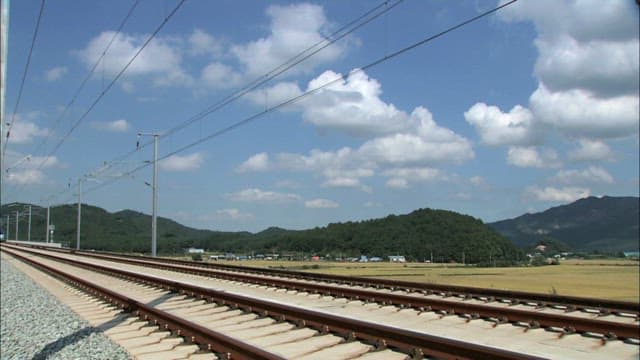 High-speed train passing through the countryside on a bright sunny day