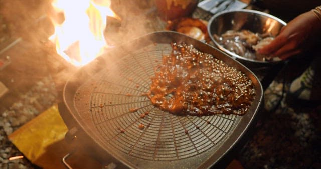 Sizzling squid being cooked on a grill