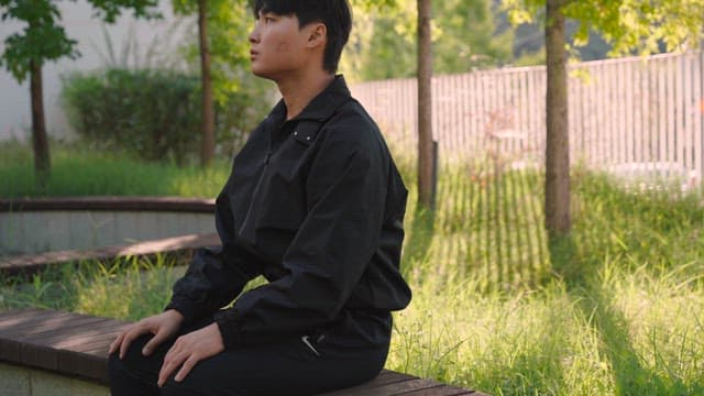 Person sitting on a bench in a park