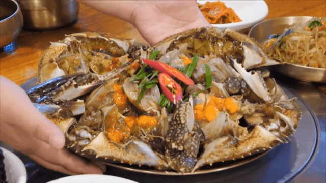 Fresh and generous soy sauce marinated crab served on a restaurant table