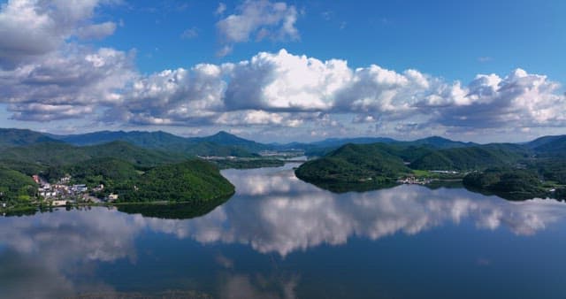 Serene lake surrounded by mountains and a village