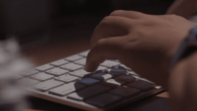 Person typing on a keyboard