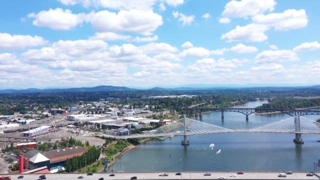 Daytime aerial view of a Morrison bridge and cityscape with vehicles
