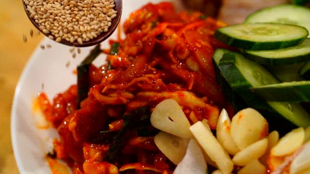 Spicy and sour swordtip squid salad with sesame seeds