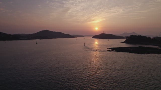 Sunset over a calm sea with distant islands