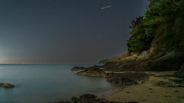 Tranquil night beach with starry sky