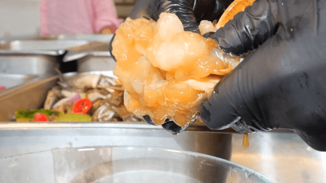 Preparing and eating fresh soy sauce marinated crab with rice