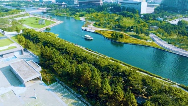 Serene Green Park with River and Moving Boat