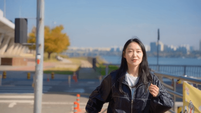 Woman jogging along a riverside path