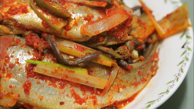 Braised yellow croaker on a plate on the table