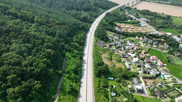 Highway Between Lush Green Space and Residential Areas