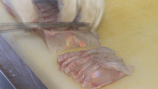 Preparing Sashimi Slices on a Kitchen Cutting Board