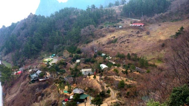 Coastal road winding alongside the ocean and mountains.