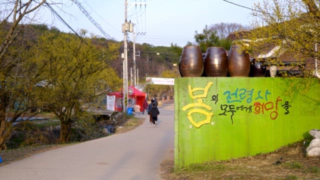 Quiet country road in Sansuyu Village with people walking