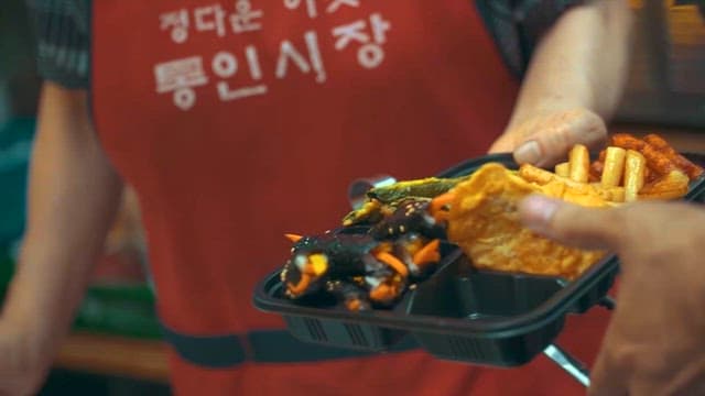 Store Owner Selling Meal Boxes at the Market