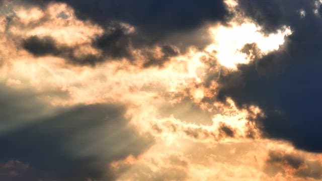 Sunlight breaking through dark clouds