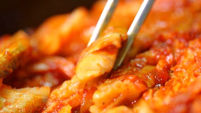 Chopsticks holding spicy braised half-dried pollack