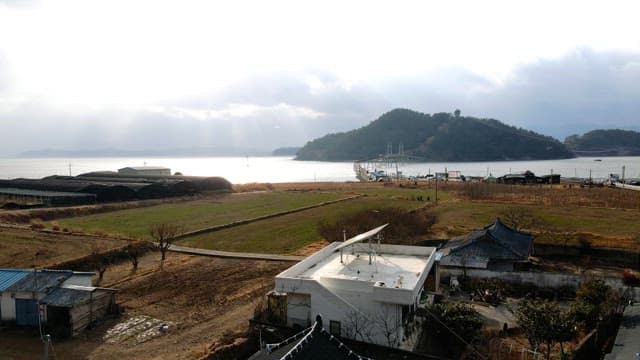 Peninsula bridge over vast sea during cloudy afternoon