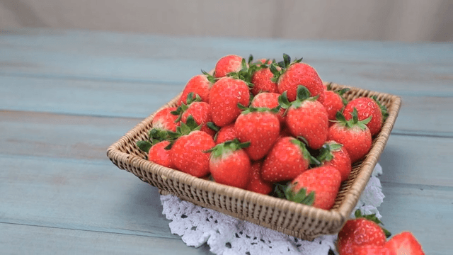 Basket of fresh strawberries on a table