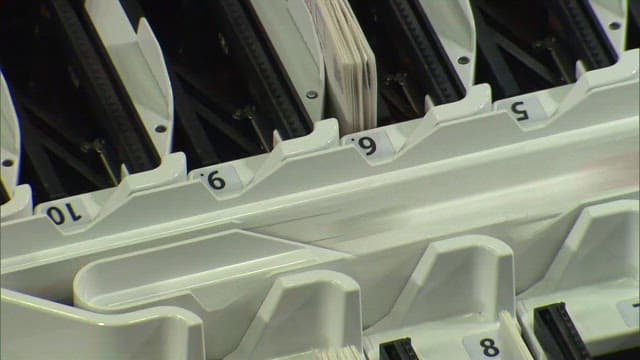 Machine operating busily and sorting ballots