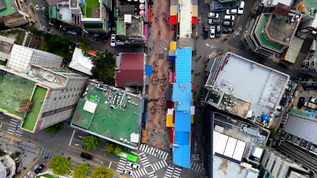 Road that runs along the buildings of a bustling city