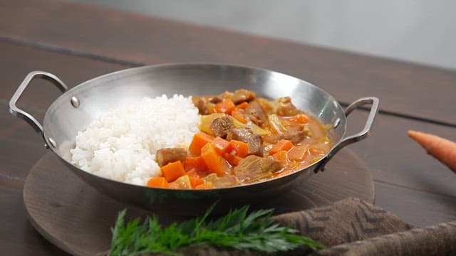 Curry Rice with Plenty of Carrots and Meat Served on the Table