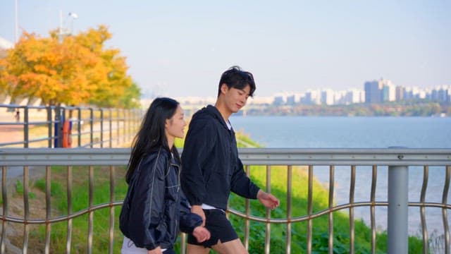 Couple jogging by the riverside