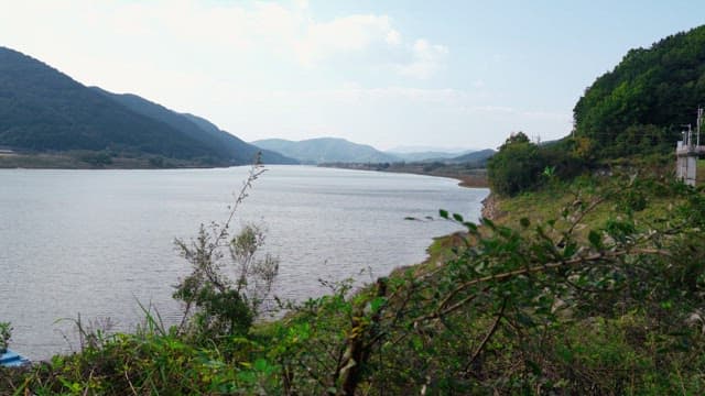 Calm river bends through lush green mountainsides