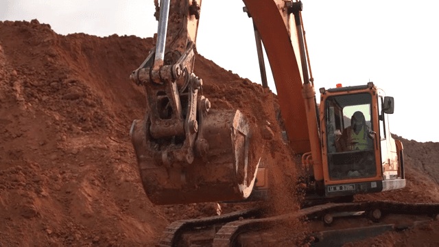 Excavator moving soil at a construction site