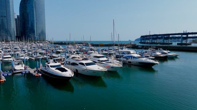 Peaceful coastal town marina with yachts anchored on a sunny day