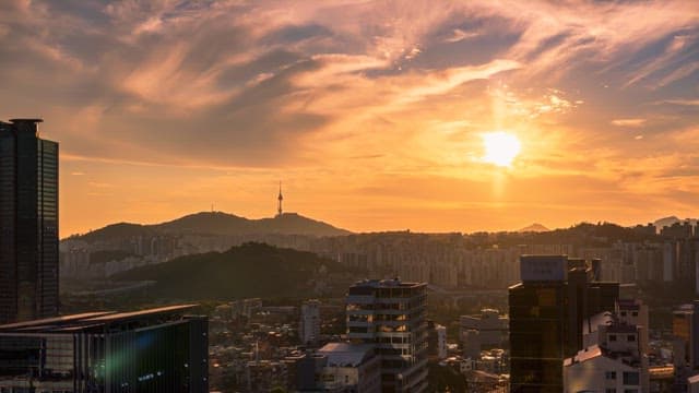 Cityscape with a dramatic sunset over the mountains