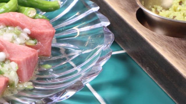Plated raw meat with green garnish
