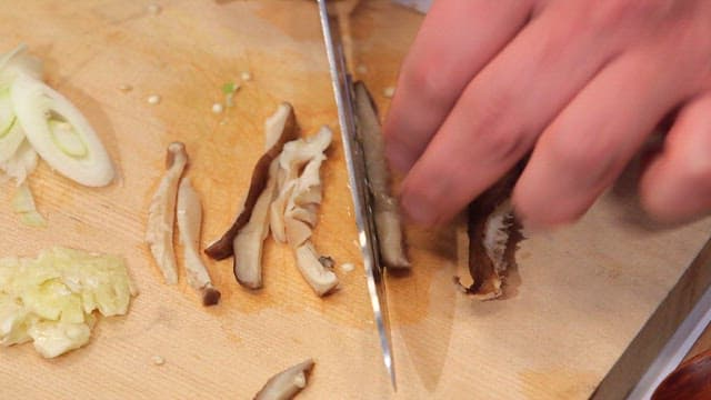 Slicing mushrooms and vegetables on a cutting board