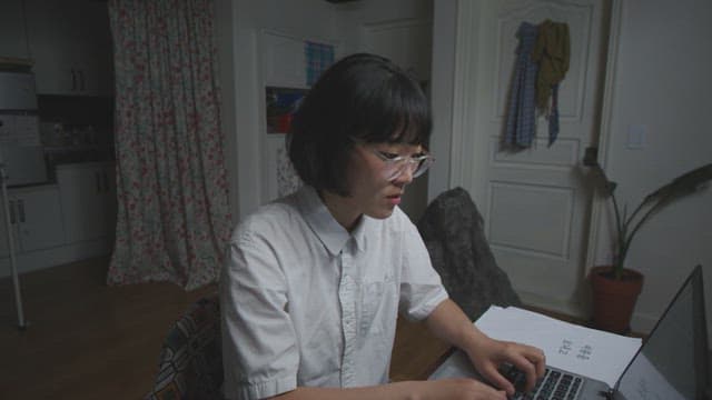 Adult woman working on a laptop indoors