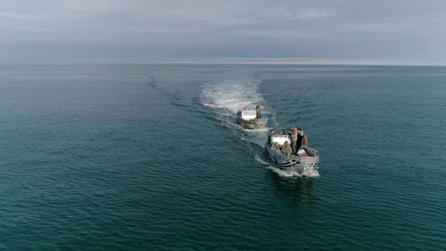 Boats speeding on the serene ocean