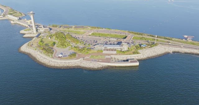 Long bridge connecting to a city skyline