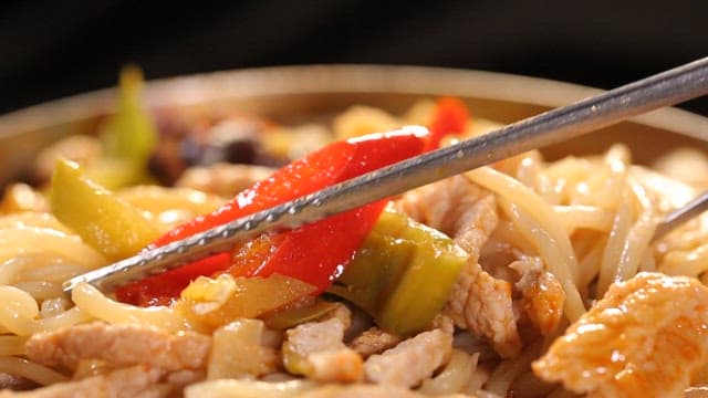 Chopstickful of spicy chili jjambbong with vegetables and meat