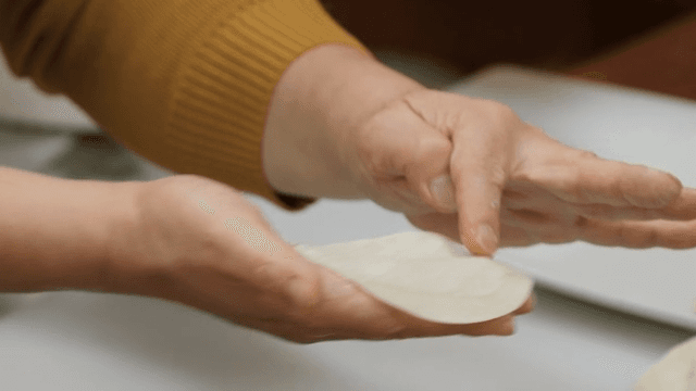 Preparing dumplings by hand in a kitchen