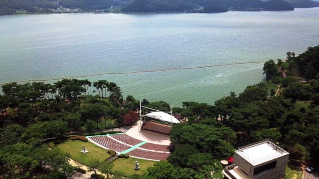 Peaceful scenic view of lakeside amphitheater and surrounding nature
