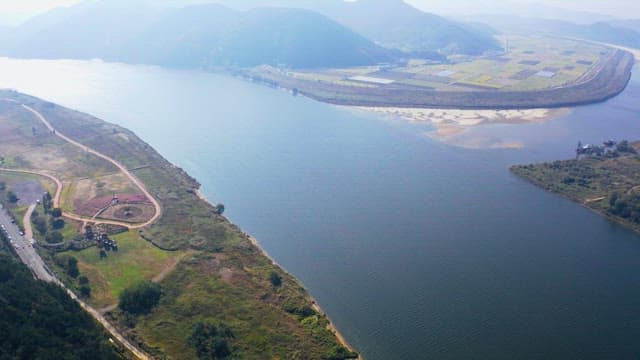 View of a riveside with farmlands and park